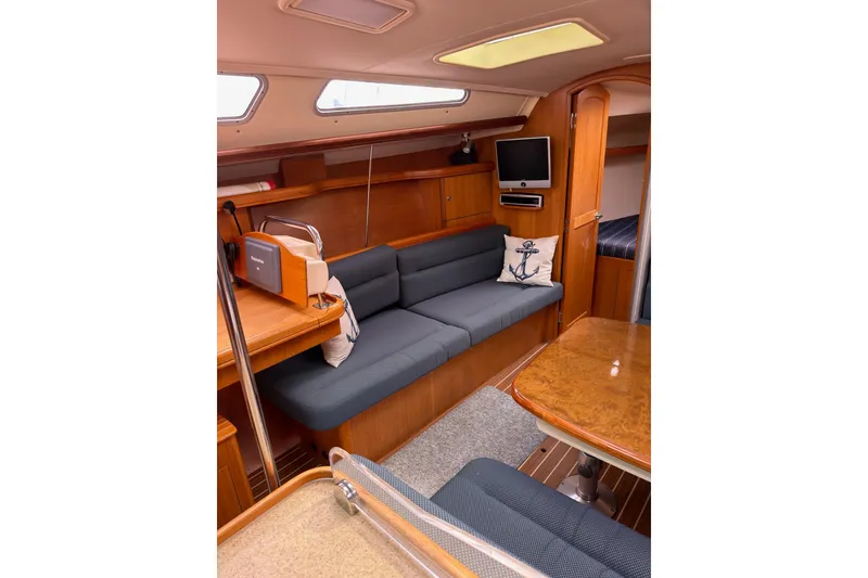 Slide: The Image of Interior of 2007 Hunter 38 sailboat with cozy seating and wooden finishes. - 16