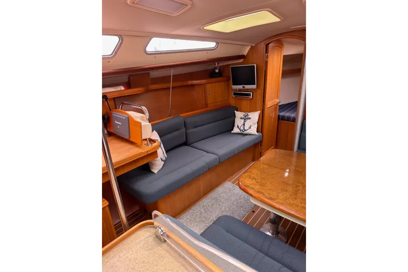 Slide: The Image of Interior of 2007 Hunter 38 sailboat with cozy seating and wooden finishes. - 18