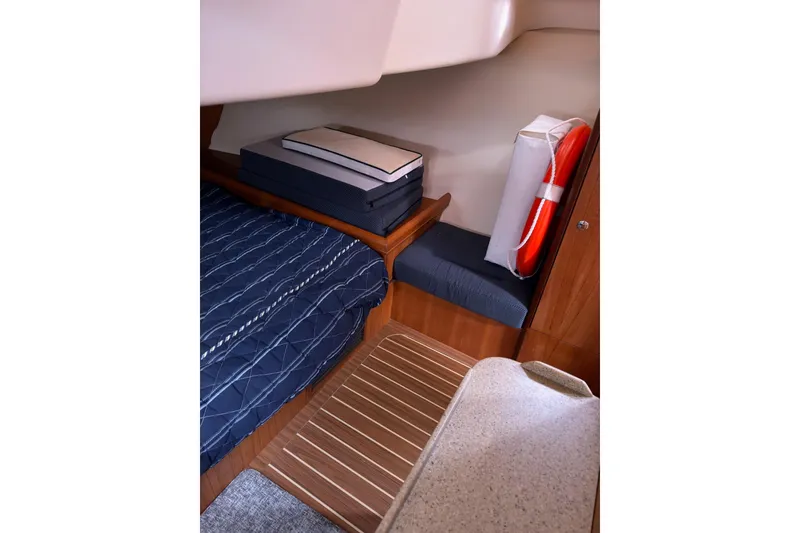 Slide: The Image of Cozy cabin interior of 2007 Hunter 38 sailboat with bed and life preserver. - 23