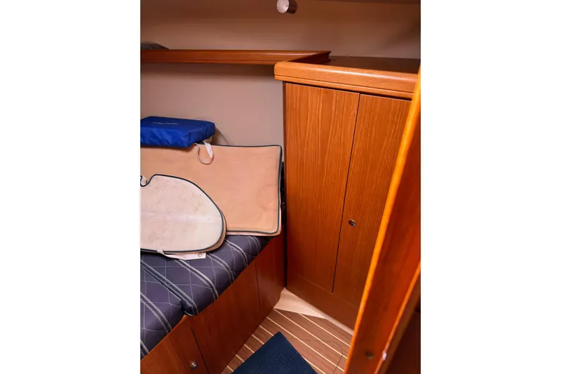 Slide: The Image of Interior cabin of 2007 Hunter 38 sailboat with wooden cabinetry and cushioned seating. - 25