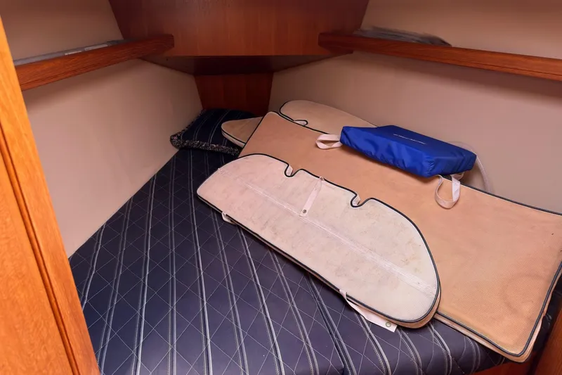 Slide: The Image of Cozy cabin interior of 2007 Hunter 38 sailboat with cushions and storage. - 26