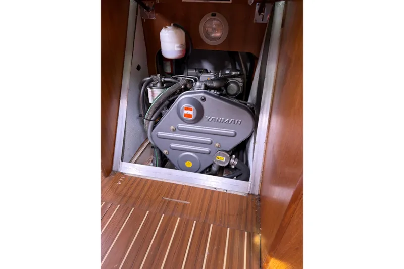 Slide: The Image of Yanmar engine inside a 2007 Hunter 38 sailboat, showcasing wooden interior. - 29
