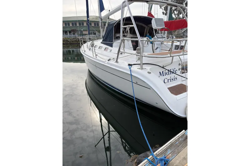 The Image of 2007 Hunter 38 sailboat named "Midlife Crisis" docked at a marina. - 6