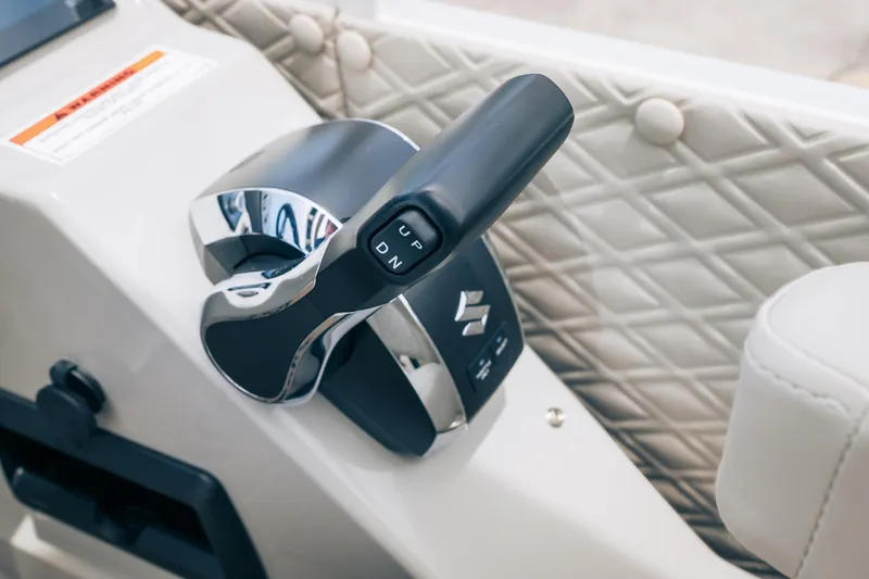Slide: The Image of Close-up of 2026 JC Sporttoon 26TT boat throttle control with quilted upholstery. - 10
