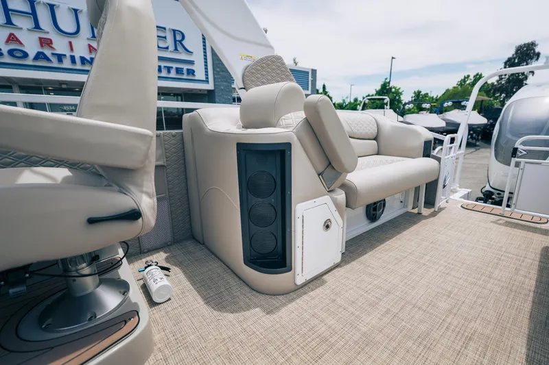 Slide: The Image of Interior of 2026 JC Sporttoon 26TT boat with beige seating and speaker system. - 12