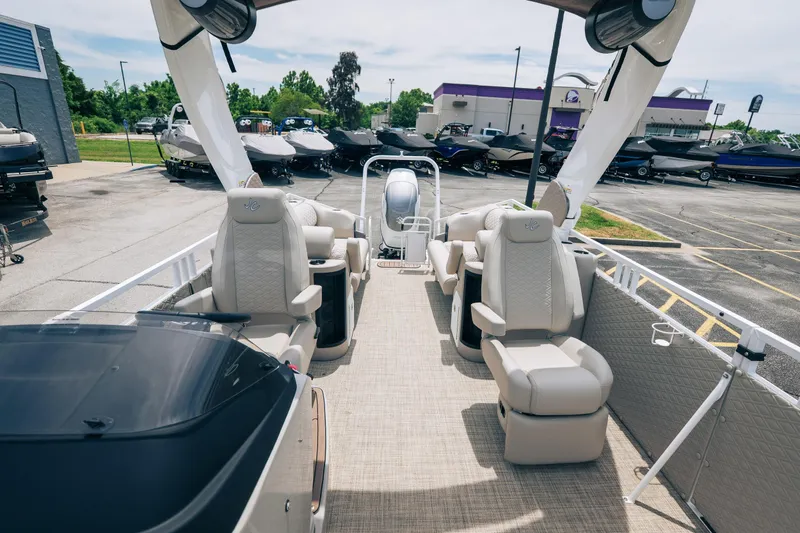 Slide: The Image of Luxury JC Sporttoon 26TT pontoon boat interior, 2026 model, in a dealership lot. - 21