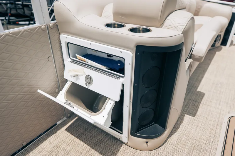 Slide: The Image of Interior of 2026 JC Sporttoon 26TT boat with storage compartment and speakers. - 26