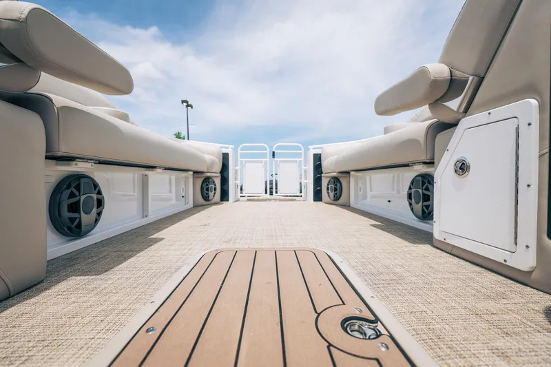 Slide: The Image of Interior view of 2026 JC Sporttoon 26TT pontoon boat with beige seating and speakers. - 27