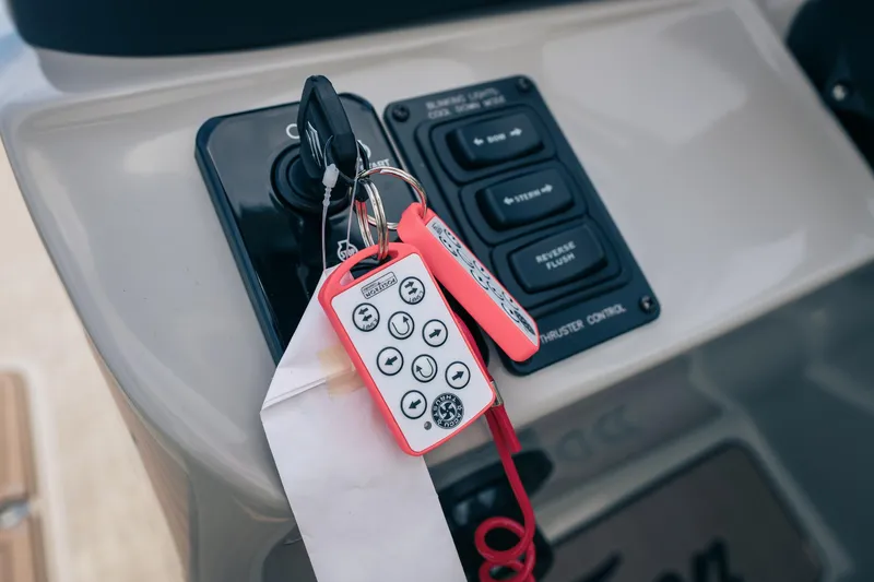 Slide: The Image of Control panel of 2026 JC Sporttoon 26TT boat with keys and remote. - 31