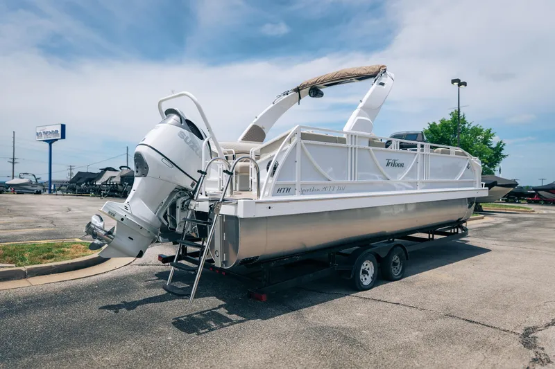 Slide: The Image of 2026 JC Sporttoon 26TT pontoon boat on trailer, parked outdoors under clear sky. - 37