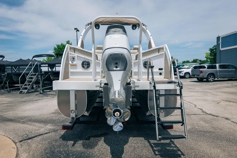 Slide: The Image of Rear view of a 2026 JC Sporttoon 26TT boat with outboard motor and ladder. - 38