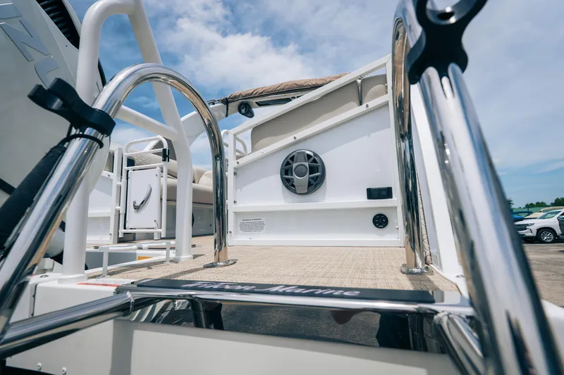 Slide: The Image of 2026 JC Sporttoon 26TT boat deck with stainless steel railings and speaker system. - 6
