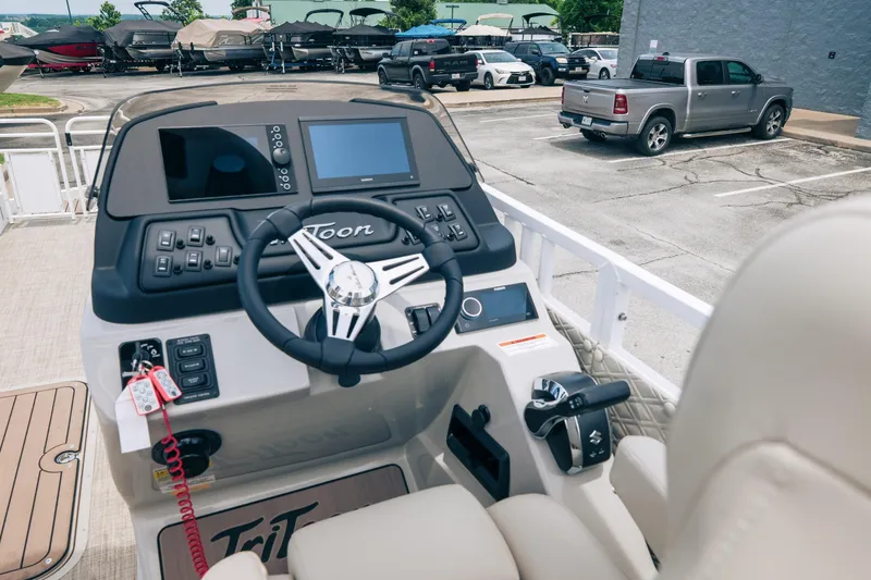 Slide: The Image of Steering console of 2026 JC Sporttoon 26TT boat, featuring modern controls and dashboard. - 8