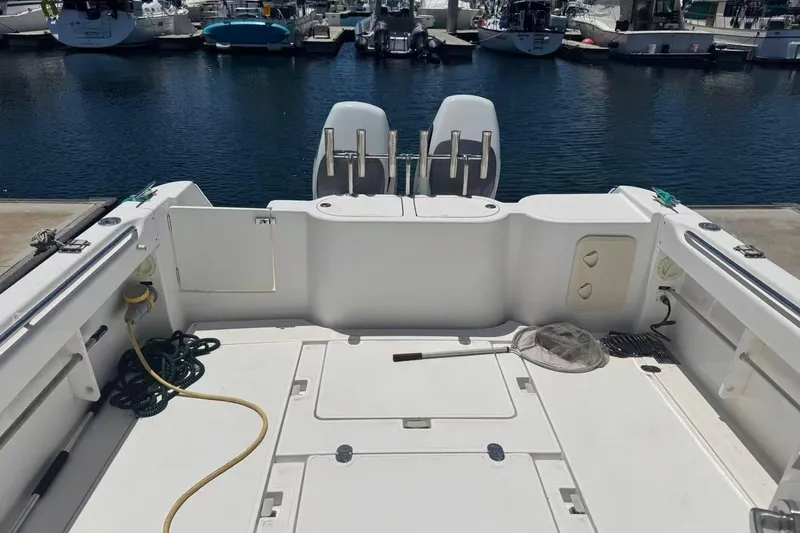 Slide: The Image of 2024 Bluewhale 3600 WA boat deck with fishing gear and marina view. - 10