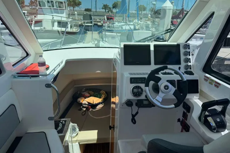 Slide: The Image of Interior of 2024 Bluewhale 3600 WA boat with modern steering and navigation systems. - 12