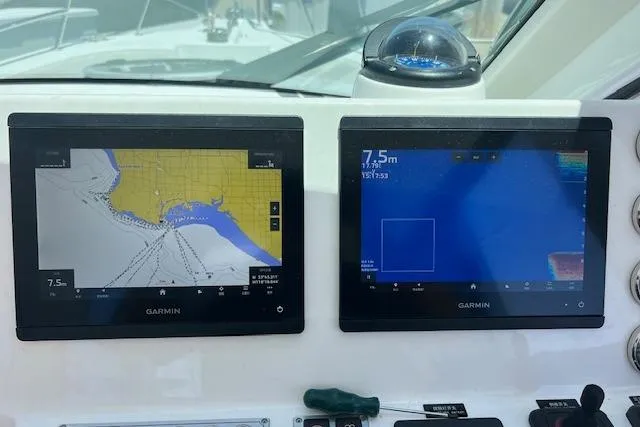 Slide: The Image of Dual Garmin displays on 2024 Bluewhale 3600 WA boat dashboard, showing navigation and sonar. - 13