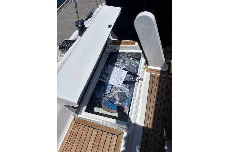 Slide: The Image of Open storage compartment on 2024 Bluewhale 3600 WA boat with wooden deck. - 20