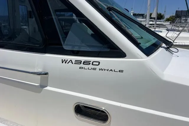 Slide: The Image of 2024 Blue Whale 3600 WA boat, sleek white exterior with model branding. - 24