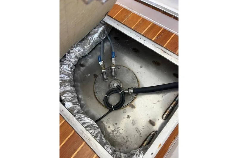 Slide: The Image of Fuel tank compartment of 2024 Bluewhale 3600 WA boat, showing hoses and fittings. - 27