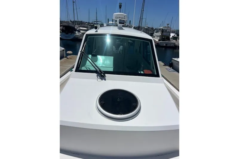 Slide: The Image of 2024 Bluewhale 3600 WA boat docked at marina, featuring Garmin equipment. - 33