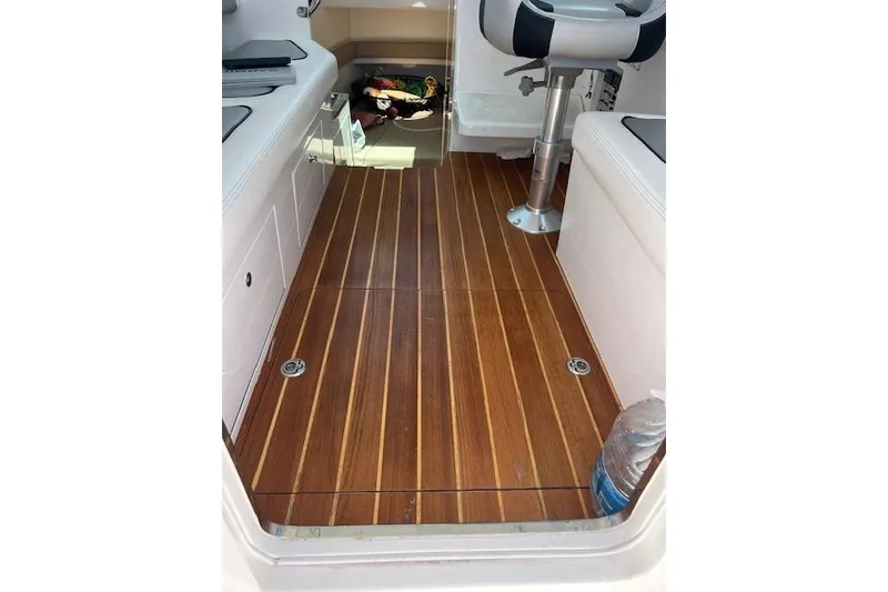 Slide: The Image of 2024 Bluewhale 3600 WA boat interior with wooden flooring and seating. - 36