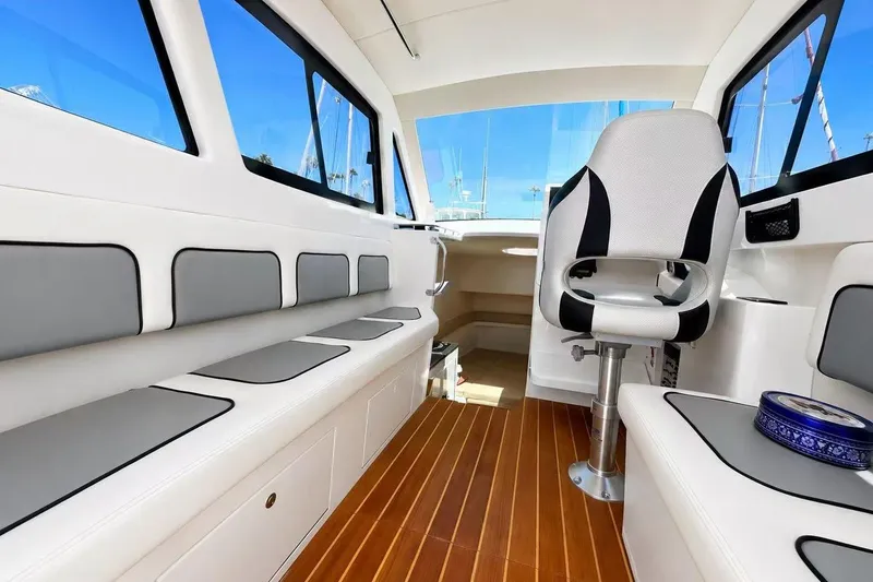 Slide: The Image of Interior of 2024 Bluewhale 3600 WA boat with modern seating and wooden flooring. - 5