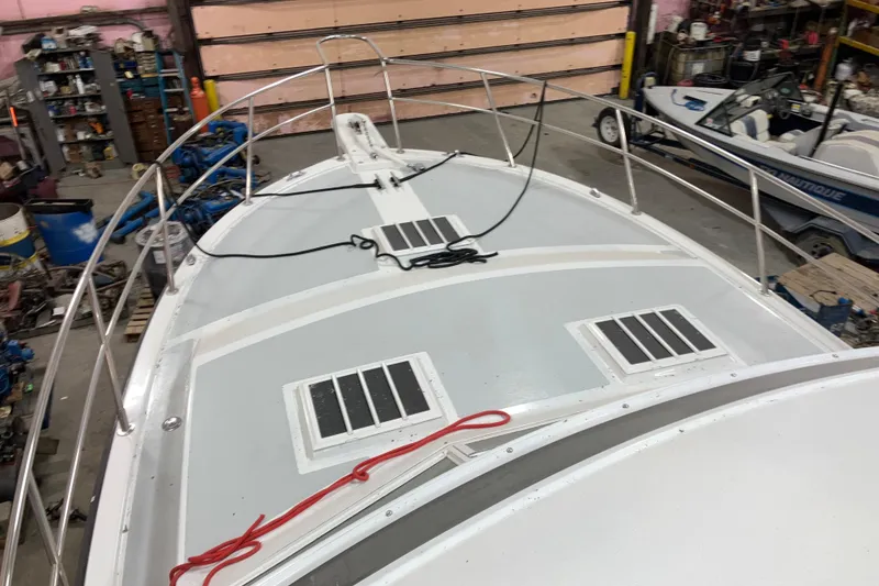 Slide: The Image of 1982 Trojan F-32 boat in a workshop, showcasing deck and railing details. - 20
