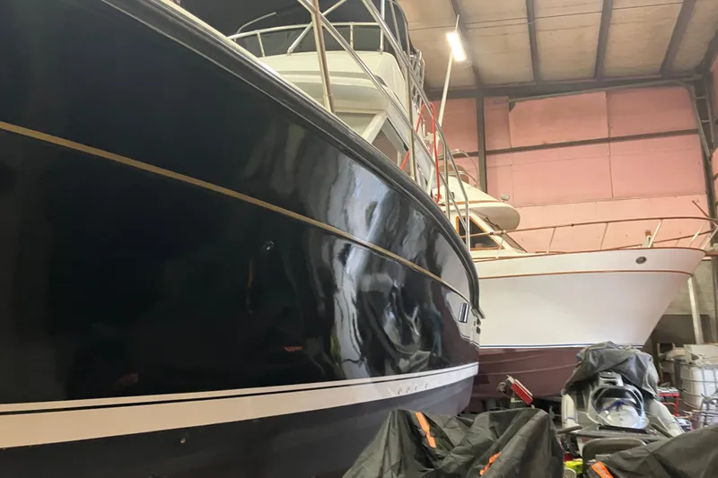 Slide: The Image of 1982 Trojan F-32 boat in storage, showcasing sleek design and polished hull. - 6