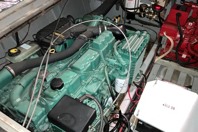 Slide: The Image of Engine compartment of a 1982 Trojan F-32 boat, showcasing mechanical components. - 21
