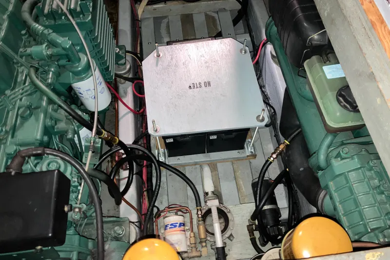 Slide: The Image of Engine compartment of a 1982 Trojan F-32 boat, showcasing mechanical components and wiring. - 22