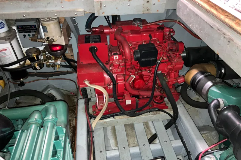 Slide: The Image of Engine room of a 1982 Trojan F-32 boat with visible red and green machinery. - 23