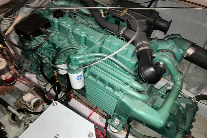 Slide: The Image of Engine of a 1982 Trojan F-32 boat, showcasing intricate mechanical components. - 24