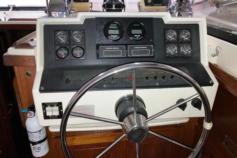 Slide: The Image of 1982 Trojan F-32 boat helm with gauges, steering wheel, and control panel. - 10