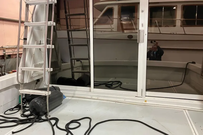 Slide: The Image of 1982 Trojan F-32 boat interior with ladder and reflective glass doors. - 8