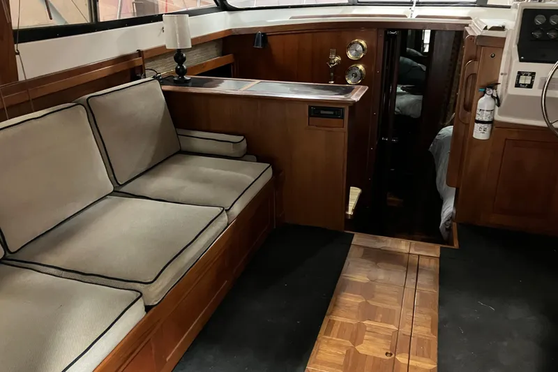 Slide: The Image of Interior of 1982 Trojan F-32 boat with wooden furnishings and cushioned seating. - 9