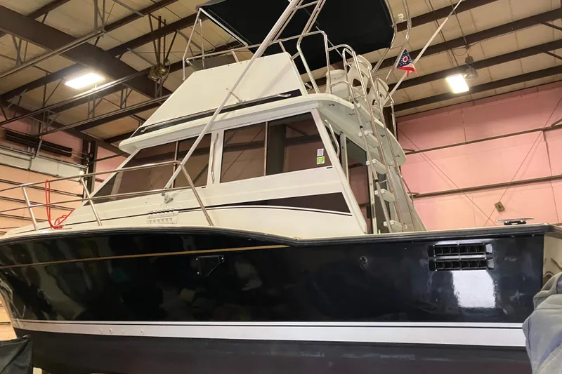 Slide: The Image of 1982 Trojan F-32 boat in indoor storage, showcasing sleek design and sturdy build. - 25