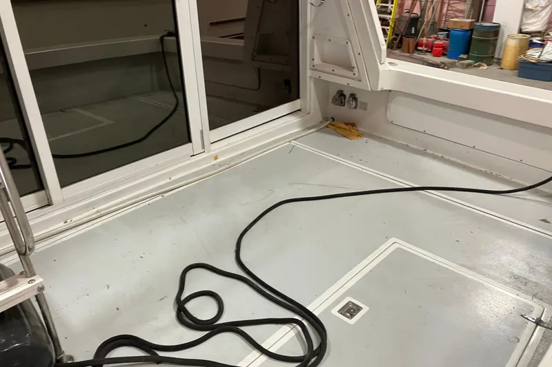 Slide: The Image of Interior of a 1982 Trojan F-32 boat with visible cables and storage compartments. - 7