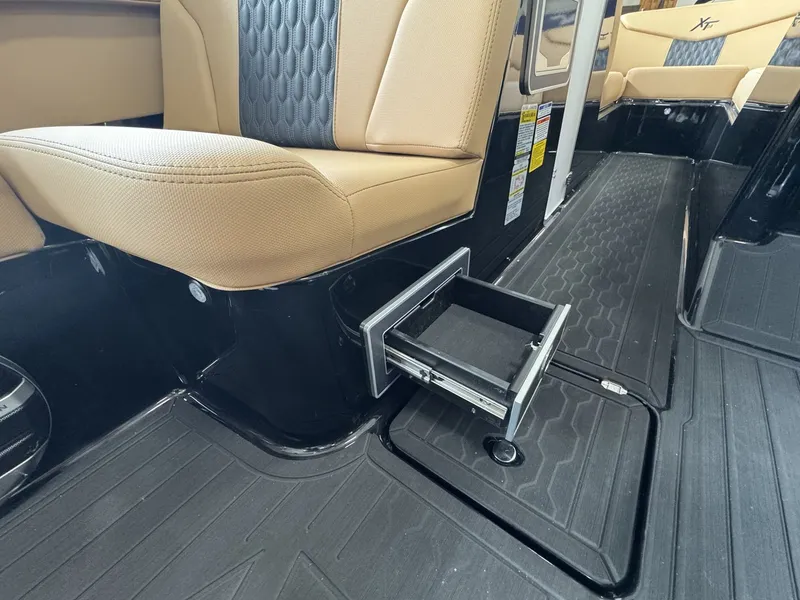 Slide: The Image of Interior of a 2026 MasterCraft XT22 with beige seating and black flooring. - 21