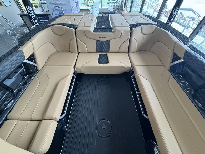 Slide: The Image of Interior of a 2026 MasterCraft XT22 with beige seating and black flooring. - 10