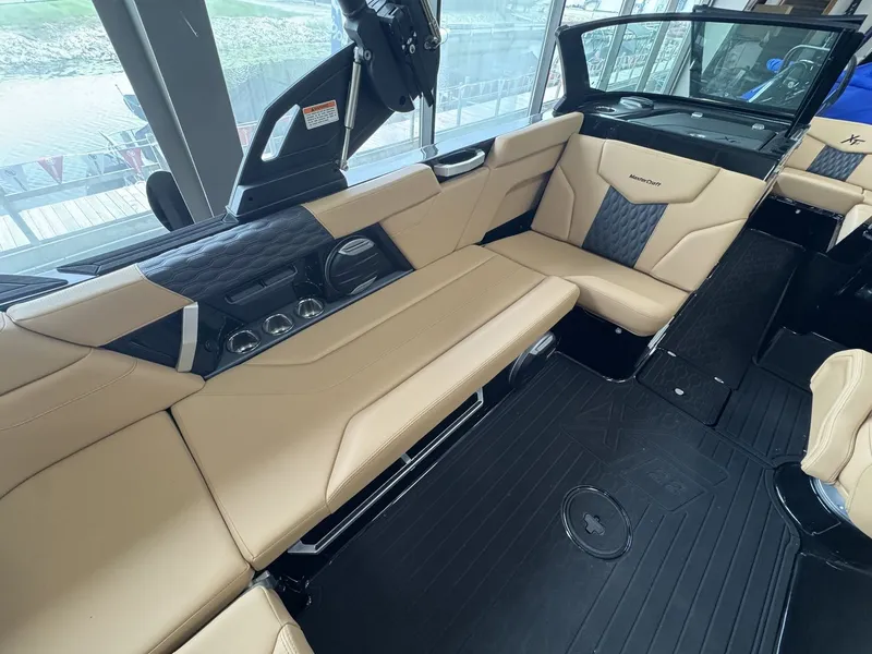 Slide: The Image of Interior of the 2026 MasterCraft XT22 with beige leather seating and modern design. - 6