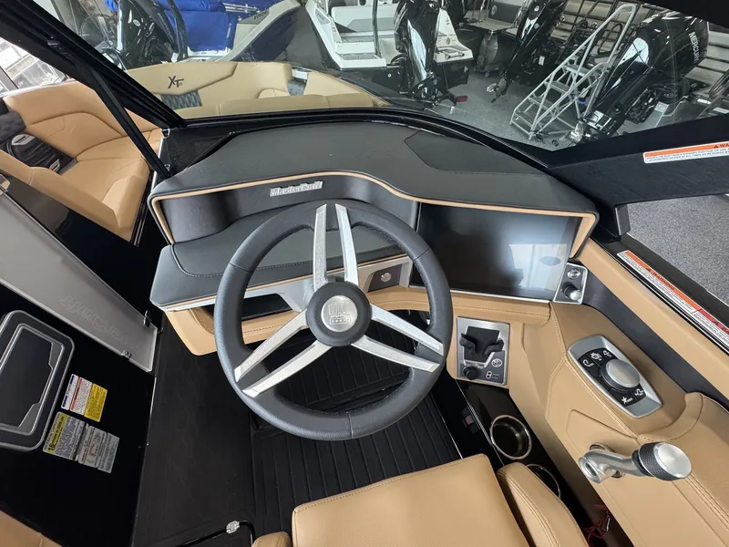 Slide: The Image of The image shows the cockpit of a 2026 MasterCraft XT22 with a modern steering wheel and touchscreen. - 14