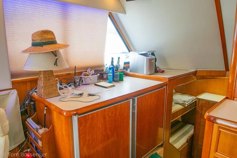 Slide: The Image of Interior of 1988 Chris-Craft 482 Convertible yacht with wooden cabinetry and nautical decor. - 11