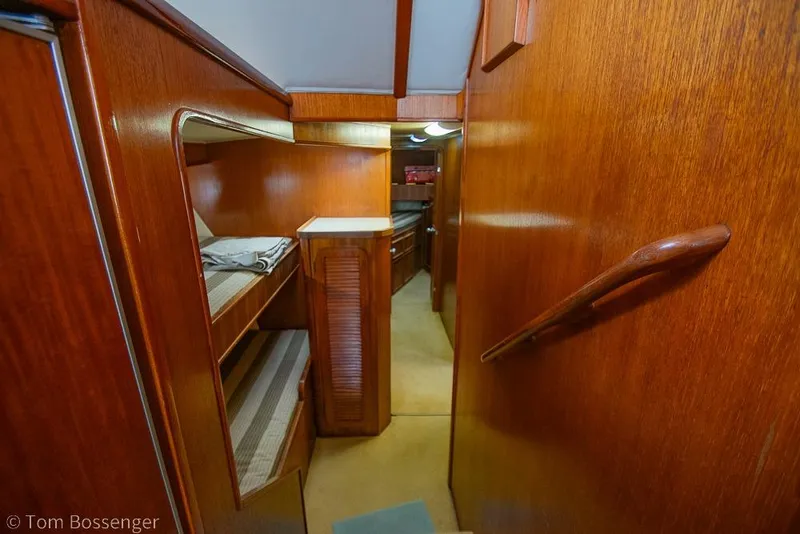 Slide: The Image of Interior of 1988 Chris-Craft 482 Convertible yacht with wooden paneling and bunk beds. - 13
