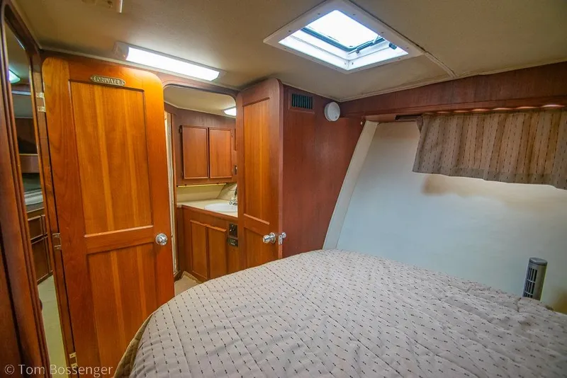 Slide: The Image of Interior cabin of 1988 Chris-Craft 482 Convertible yacht with wood paneling and skylight. - 15