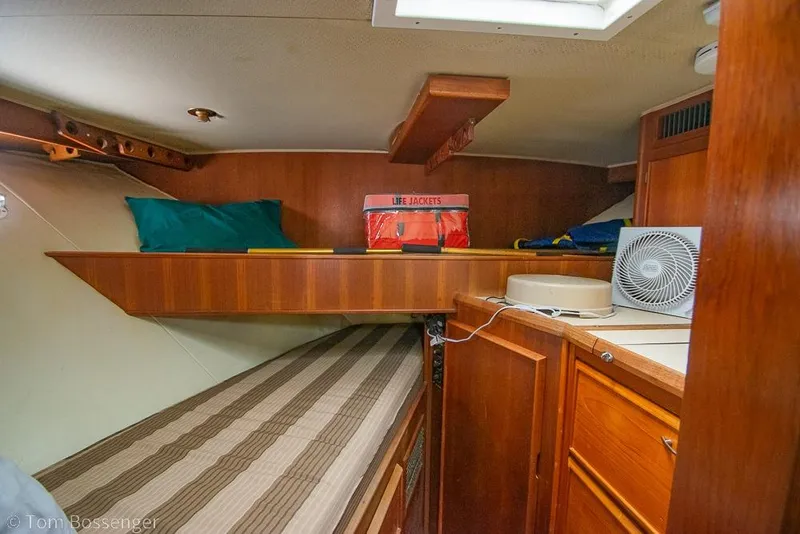 Slide: The Image of Interior cabin of 1988 Chris-Craft 482 Convertible with wooden furnishings and life jackets. - 18