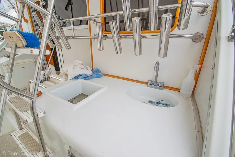 Slide: The Image of 1988 Chris-Craft 482 Convertible boat deck with sink and rod holders. - 24