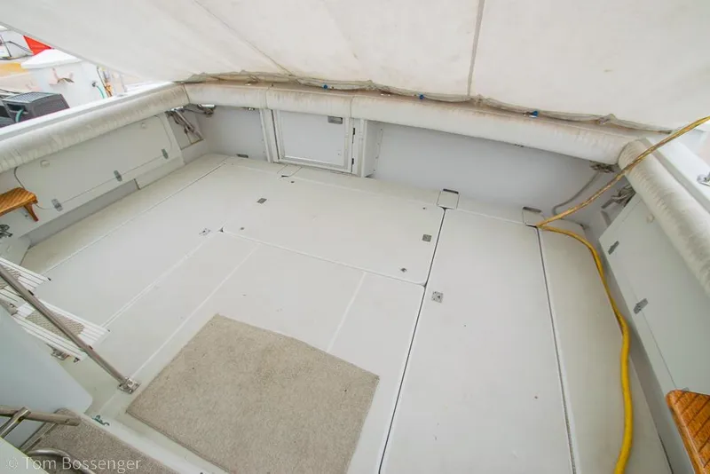Slide: The Image of Spacious deck of 1988 Chris-Craft 482 Convertible yacht with white flooring and seating. - 26
