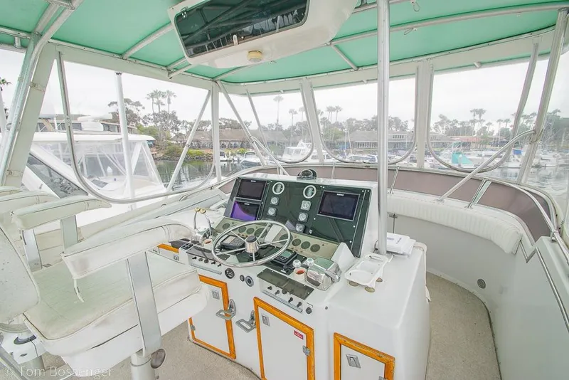 Slide: The Image of Interior helm of 1988 Chris-Craft 482 Convertible yacht with steering wheel and navigation instruments. - 27