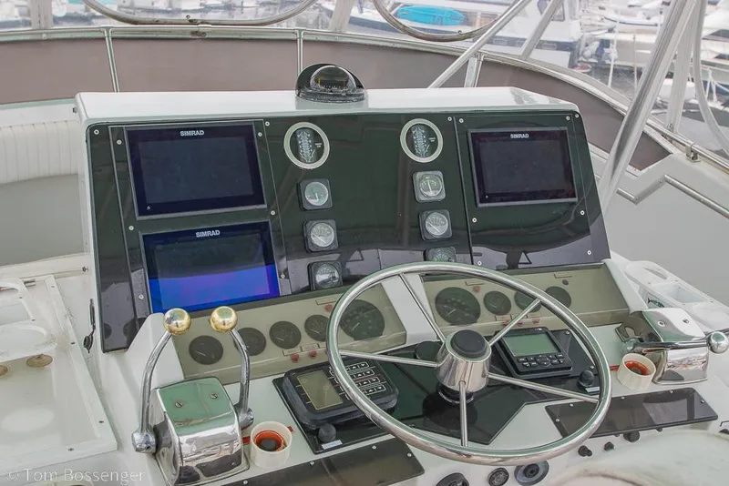 Slide: The Image of Cockpit of 1988 Chris-Craft 482 Convertible with navigation instruments and steering wheel. - 29