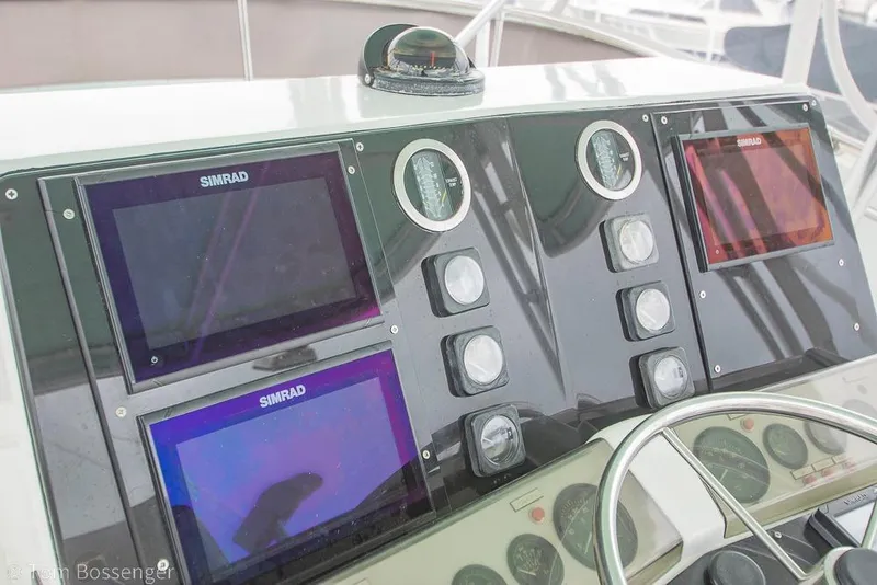 Slide: The Image of Control panel of a 1988 Chris-Craft 482 Convertible boat with Simrad displays. - 30